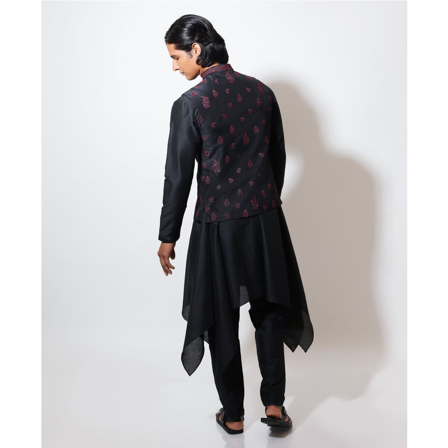 Sleeveless bandi with double tone motif embroidery layered over handkerchief hem kurta