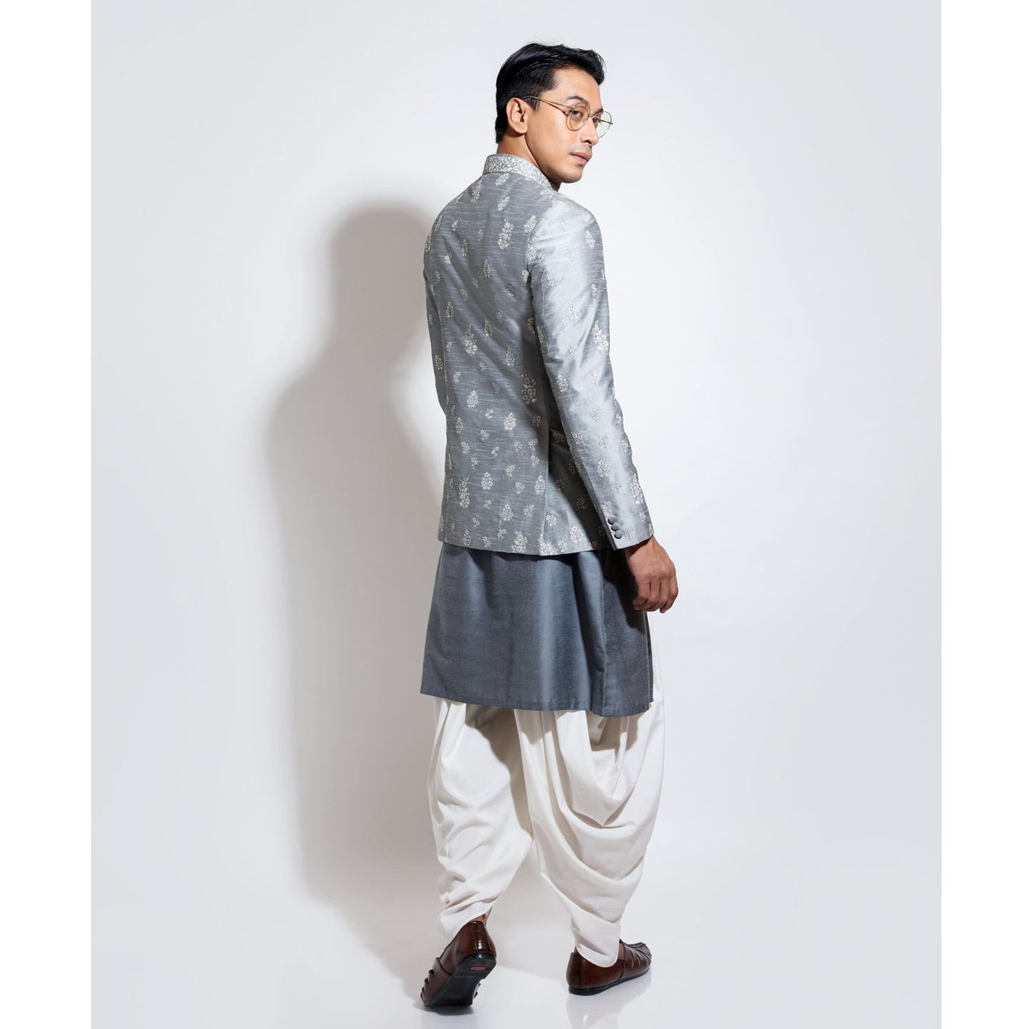 Bandhgala with motif embroidery layered over updown hem kurta and cowl pants