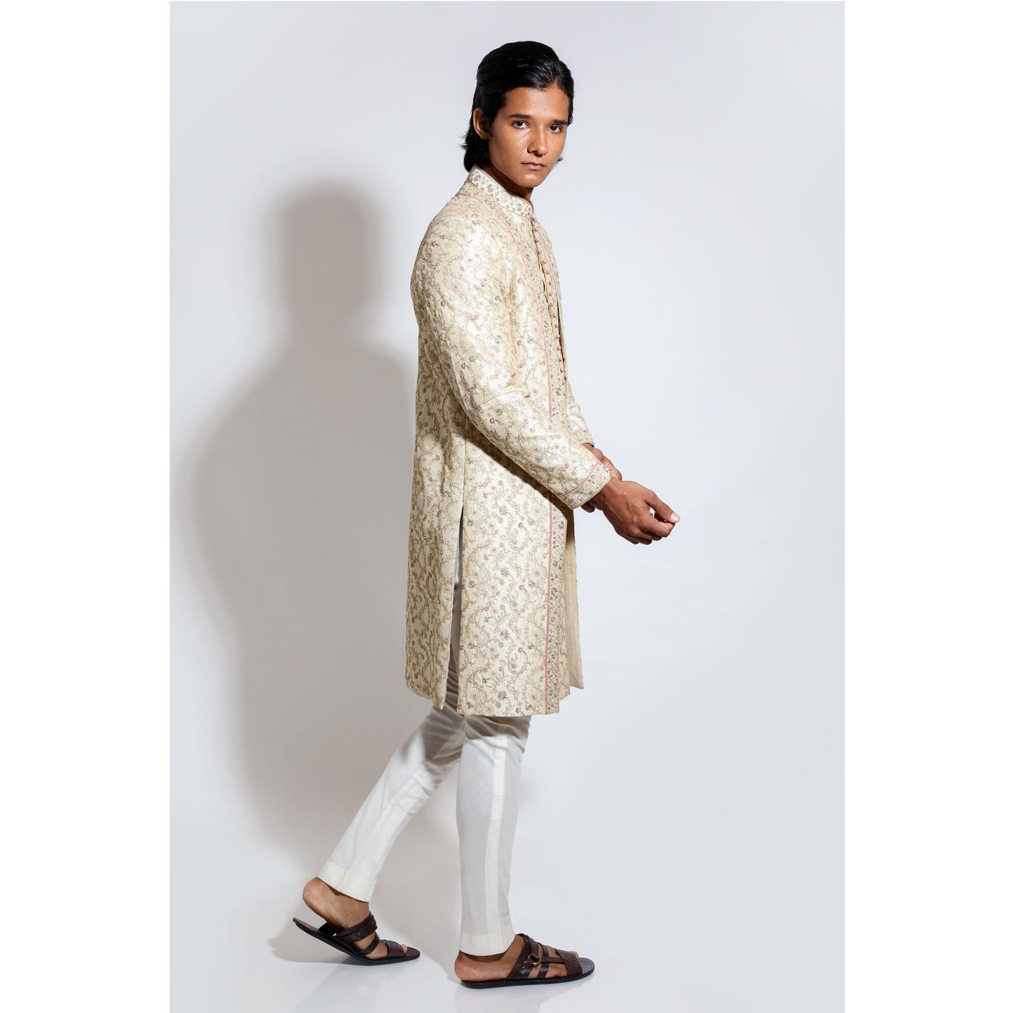 Sherwani with all over emb and layered front with border with cropped pants