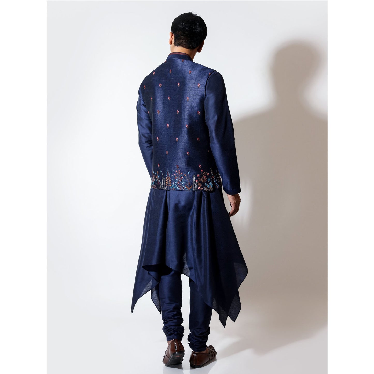 Sleeveless bandi with multicolor floral embroidery layered over handkerchief hem kurta