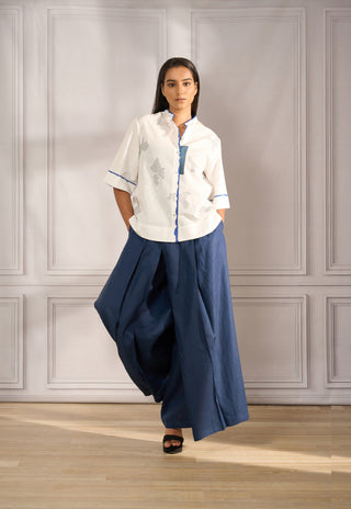Boxy top in white linen with handpainted edges paired with pleated pallazo in navy linen