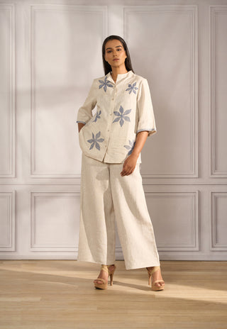 Boxy top in beige linen with floral embroidery paired with straight pants